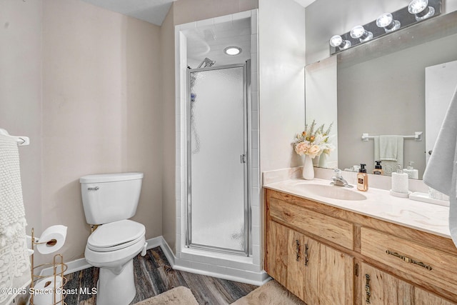 9040 York Ln Unit 16G, West Melbourne, FL 32904 - full bath featuring vanity, a shower stall, toilet, wood finished floors, and baseboards