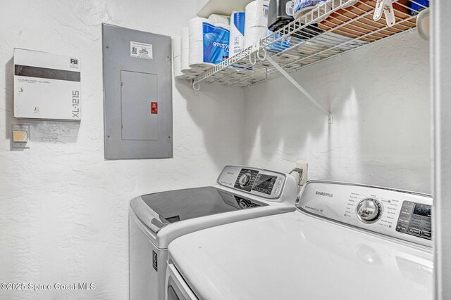 9040 York Ln Unit 16G, West Melbourne, FL 32904 - laundry area with electric panel, washer and dryer, and a textured wall