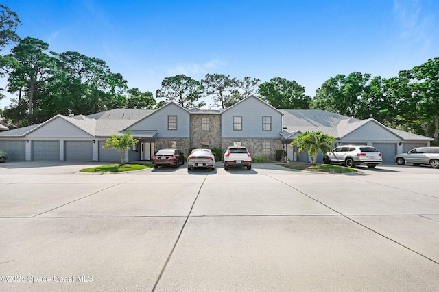 9040 York Ln Unit 16G, West Melbourne, FL 32904 - view of front of property with stone siding and concrete driveway