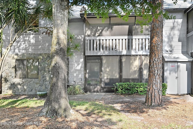 9040 York Ln Unit 16G, West Melbourne, FL 32904 - rear view of property featuring a balcony and stone siding