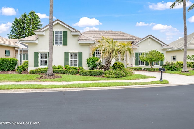 274 Clyde St, Melbourne Beach, FL 32951 - view of front facade with a tiled roof and stucco siding