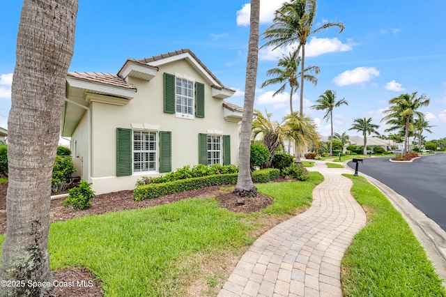 274 Clyde St, Melbourne Beach, FL 32951 - view of property exterior featuring a tile roof and stucco siding