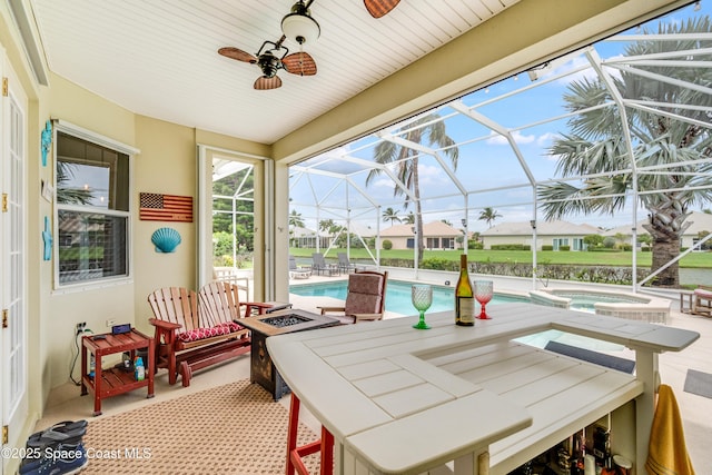 274 Clyde St, Melbourne Beach, FL 32951 - sunroom / solarium featuring a jacuzzi, ceiling fan, a pool, and a fire pit
