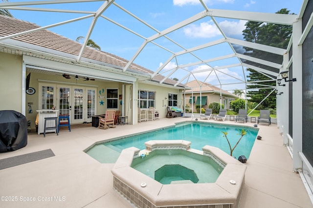 274 Clyde St, Melbourne Beach, FL 32951 - view of pool featuring french doors, a pool with connected hot tub, a patio, and glass enclosure