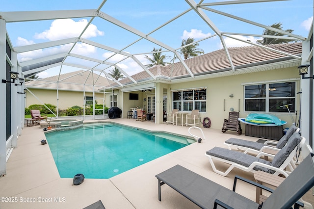 274 Clyde St, Melbourne Beach, FL 32951 - view of swimming pool with a patio area, ceiling fan, a pool with connected hot tub, and a lanai