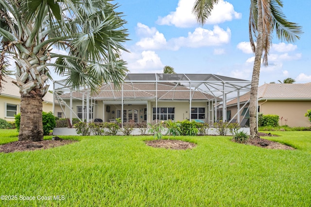 274 Clyde St, Melbourne Beach, FL 32951 - back of property with a lawn, stucco siding, and glass enclosure
