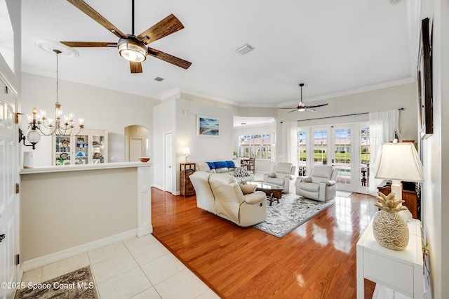 274 Clyde St, Melbourne Beach, FL 32951 - living room with ceiling fan, crown molding, a chandelier, light tile patterned floors, and baseboards