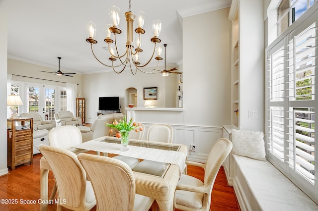 274 Clyde St, Melbourne Beach, FL 32951 - dining area featuring a ceiling fan, wood finished floors, crown molding, a chandelier, and built in shelves