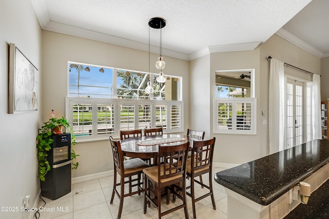 274 Clyde St, Melbourne Beach, FL 32951 - dining room featuring ornamental molding, plenty of natural light, baseboards, and light tile patterned floors