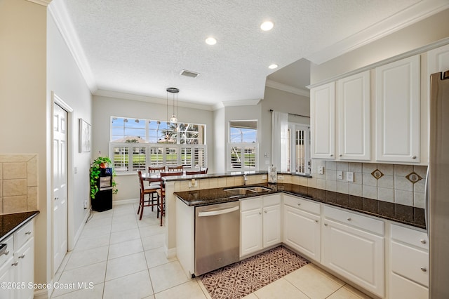 274 Clyde St, Melbourne Beach, FL 32951 - kitchen with stainless steel dishwasher, a sink, a peninsula, ornamental molding, and decorative backsplash
