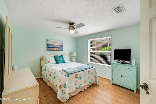 274 Clyde St, Melbourne Beach, FL 32951 - bedroom with light wood-style flooring, baseboards, a textured ceiling, and ceiling fan