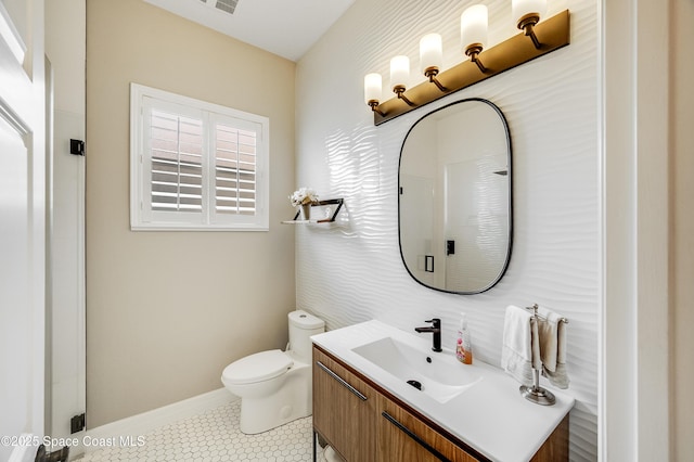 274 Clyde St, Melbourne Beach, FL 32951 - bathroom with vanity, toilet, tile patterned flooring, and baseboards