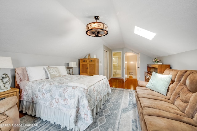 274 Clyde St, Melbourne Beach, FL 32951 - bedroom with wood finished floors, a skylight, lofted ceiling, and connected bathroom