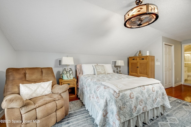 274 Clyde St, Melbourne Beach, FL 32951 - bedroom featuring vaulted ceiling, light wood-type flooring, baseboards, ensuite bath, and a textured ceiling