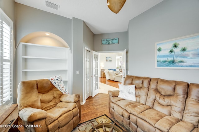 274 Clyde St, Melbourne Beach, FL 32951 - living area with wood finished floors, baseboards, and french doors