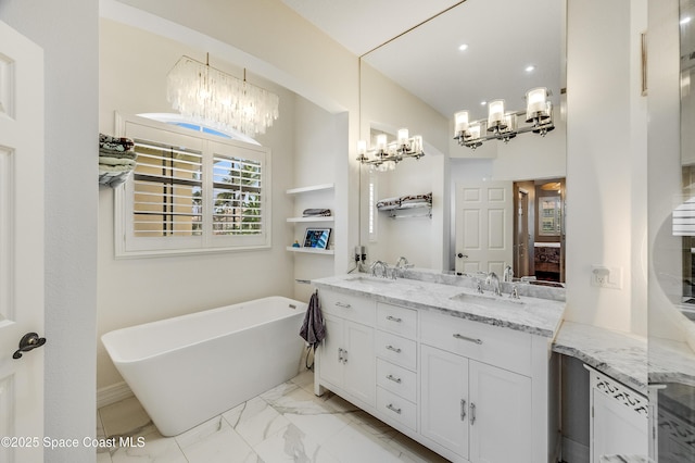 274 Clyde St, Melbourne Beach, FL 32951 - full bath with a chandelier, double vanity, a freestanding bath, marble look tiles, and recessed lighting