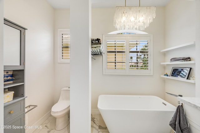 274 Clyde St, Melbourne Beach, FL 32951 - bathroom with marble look tile flooring, a freestanding bath, healthy amount of natural light, and a chandelier