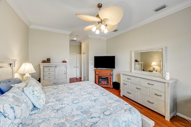 274 Clyde St, Melbourne Beach, FL 32951 - bedroom with crown molding, wood finished floors, ceiling fan, and baseboards