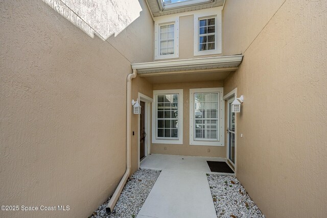 401 Trotter Ln Unit 103, Melbourne, FL 32940 - doorway to property featuring stucco siding