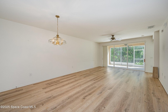 401 Trotter Ln Unit 103, Melbourne, FL 32940 - unfurnished room with light wood-style flooring, a chandelier, and ceiling fan