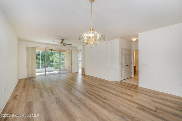 401 Trotter Ln Unit 103, Melbourne, FL 32940 - unfurnished room featuring light wood-type flooring, a ceiling fan, and a chandelier
