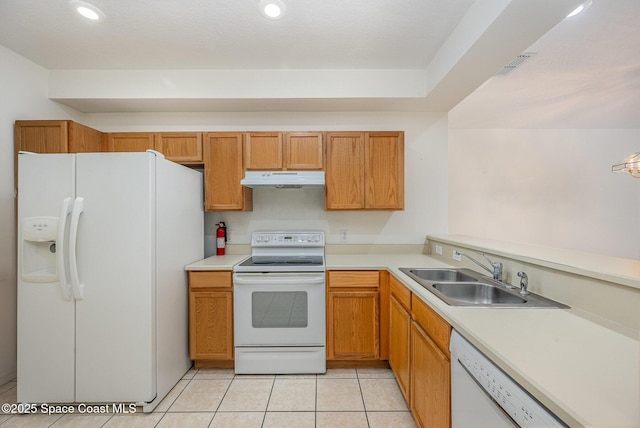 401 Trotter Ln Unit 103, Melbourne, FL 32940 - kitchen featuring white appliances, under cabinet range hood, a sink, light countertops, and recessed lighting