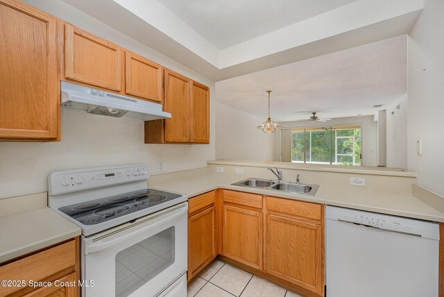 401 Trotter Ln Unit 103, Melbourne, FL 32940 - kitchen with white appliances, under cabinet range hood, a sink, and light countertops