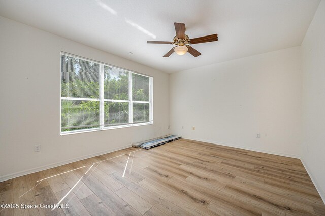 401 Trotter Ln Unit 103, Melbourne, FL 32940 - unfurnished room featuring light wood-style floors, a ceiling fan, and baseboards