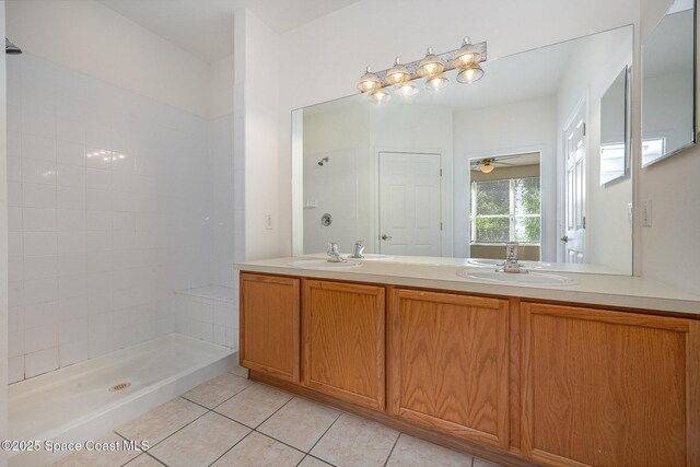 401 Trotter Ln Unit 103, Melbourne, FL 32940 - bathroom featuring tile patterned floors, double vanity, a ceiling fan, and a tile shower