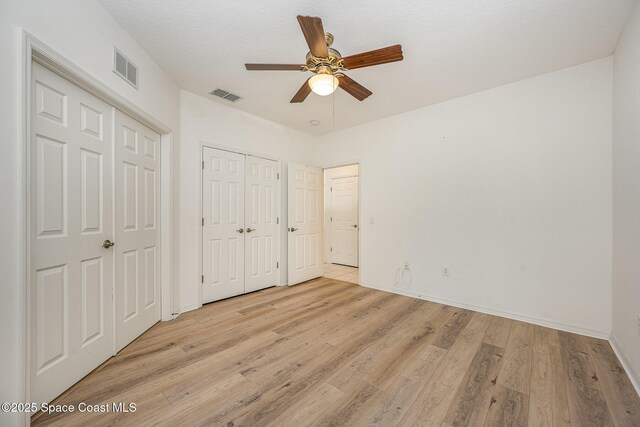 401 Trotter Ln Unit 103, Melbourne, FL 32940 - unfurnished bedroom with light wood-type flooring, baseboards, and ceiling fan