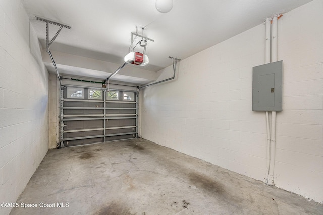 401 Trotter Ln Unit 103, Melbourne, FL 32940 - garage with electric panel, a garage door opener, and concrete block wall