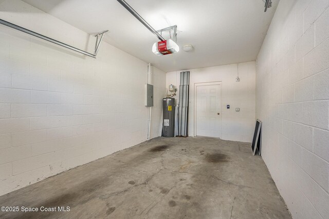 401 Trotter Ln Unit 103, Melbourne, FL 32940 - garage featuring electric water heater, electric panel, a garage door opener, and concrete block wall