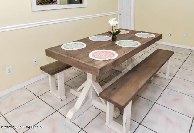 1066 Pennsylvania Ave NE, Palm Bay, FL 32907 - dining room with tile patterned flooring and baseboards