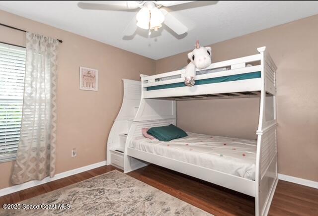 1066 Pennsylvania Ave NE, Palm Bay, FL 32907 - bedroom with baseboards, wood finished floors, and ceiling fan