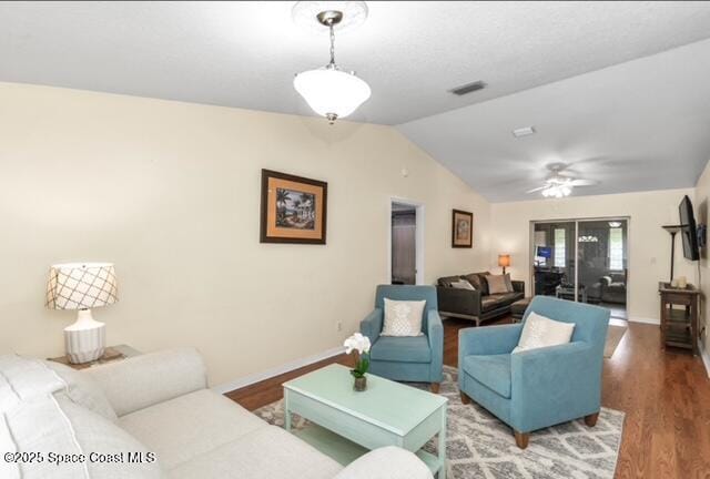 1066 Pennsylvania Ave NE, Palm Bay, FL 32907 - living area with vaulted ceiling, wood finished floors, ceiling fan, and baseboards
