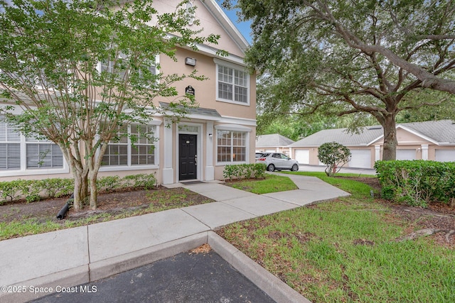 115 Turpial Way Unit 104, Melbourne, FL 32901 - view of front of property featuring stucco siding