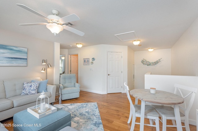 115 Turpial Way Unit 104, Melbourne, FL 32901 - living room featuring light wood-style flooring, baseboards, and ceiling fan