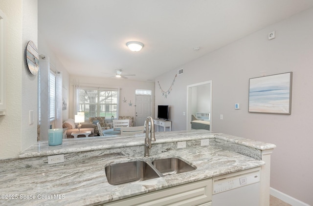 115 Turpial Way Unit 104, Melbourne, FL 32901 - kitchen featuring a sink, dishwasher, open floor plan, a ceiling fan, and light stone countertops