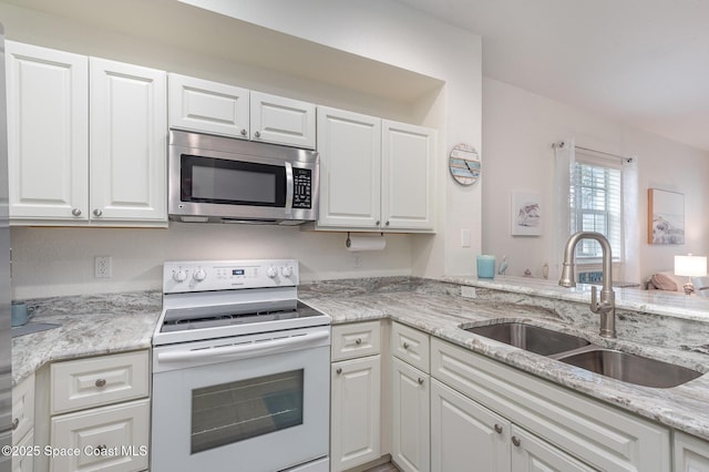115 Turpial Way Unit 104, Melbourne, FL 32901 - kitchen with white electric range oven, stainless steel microwave, a sink, and white cabinetry