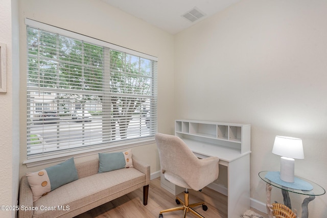 115 Turpial Way Unit 104, Melbourne, FL 32901 - home office featuring plenty of natural light, wood finished floors, and baseboards