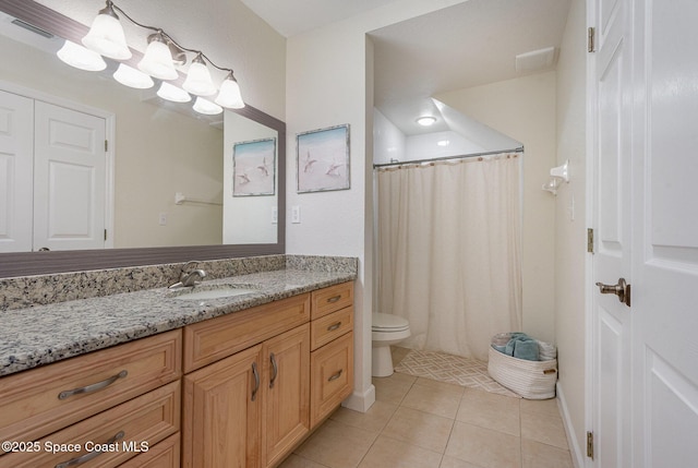 115 Turpial Way Unit 104, Melbourne, FL 32901 - bathroom with tile patterned flooring, vanity, toilet, and a shower with shower curtain
