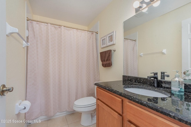 115 Turpial Way Unit 104, Melbourne, FL 32901 - full bathroom with vanity, tile patterned floors, toilet, and shower / tub combo with curtain
