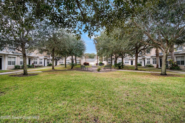 115 Turpial Way Unit 104, Melbourne, FL 32901 - view of community with a residential view and a lawn