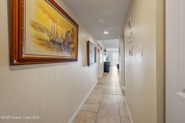4100 Ocean Beach Blvd Unit 412, Cocoa Beach, FL 32931 - corridor with light tile patterned flooring, baseboards, and a textured ceiling