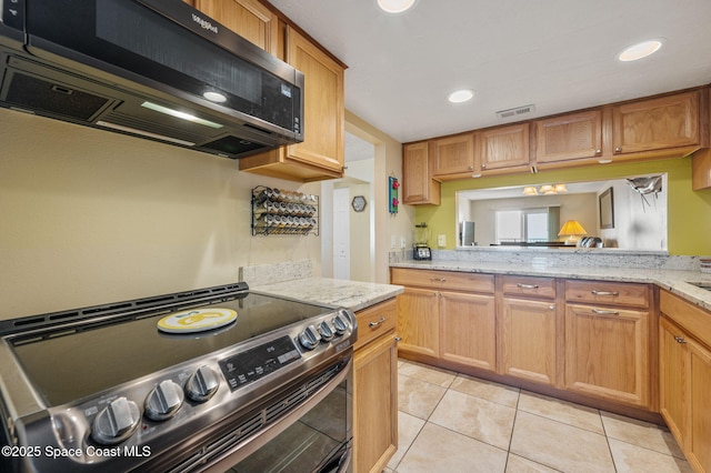4100 Ocean Beach Blvd Unit 412, Cocoa Beach, FL 32931 - kitchen featuring stainless steel electric range, light stone countertops, light tile patterned floors, and recessed lighting