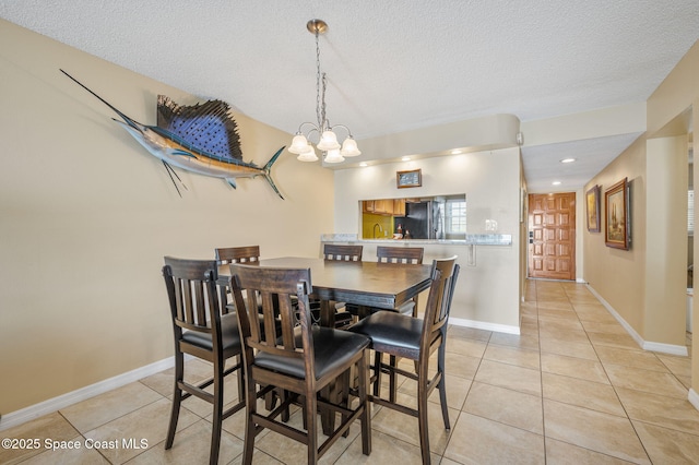 4100 Ocean Beach Blvd Unit 412, Cocoa Beach, FL 32931 - dining room with light tile patterned floors, a chandelier, a textured ceiling, baseboards, and recessed lighting