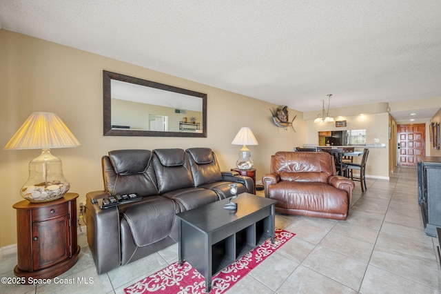 4100 Ocean Beach Blvd Unit 412, Cocoa Beach, FL 32931 - living area featuring light tile patterned floors, a textured ceiling, and baseboards