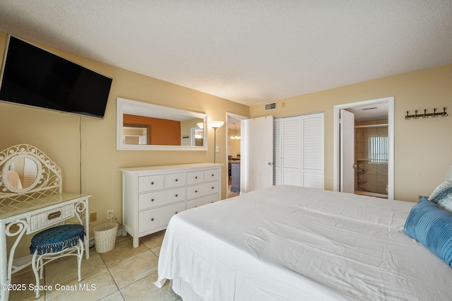 4100 Ocean Beach Blvd Unit 412, Cocoa Beach, FL 32931 - bedroom with light tile patterned flooring and ensuite bathroom