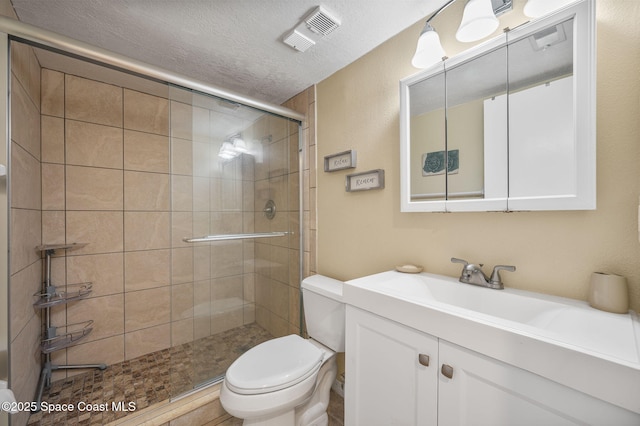 4100 Ocean Beach Blvd Unit 412, Cocoa Beach, FL 32931 - bathroom with toilet, vanity, a shower stall, and a textured ceiling