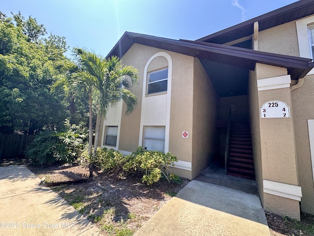 225 Spring Dr Unit 3, Merritt Island, FL 32953 - doorway to property with stucco siding